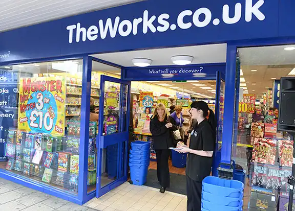 Shop front of The Works with books in the window and people leaving the store located in Sheffield City Centre