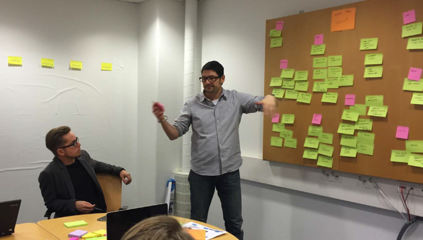 Usual designer dude in front of a wall of post-it's (actually me)
