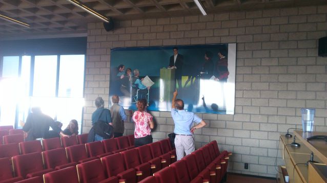 Examining the mysterious painting in the Leuven auditorium. Photo: Andrew Chesterman’s personal archives.​
