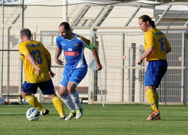 A football match between Israeli and Swedish writers in Haifa in June 2013. Juha Kanerva is trying to take the ball from the captain of the host country, Roi Shani.​