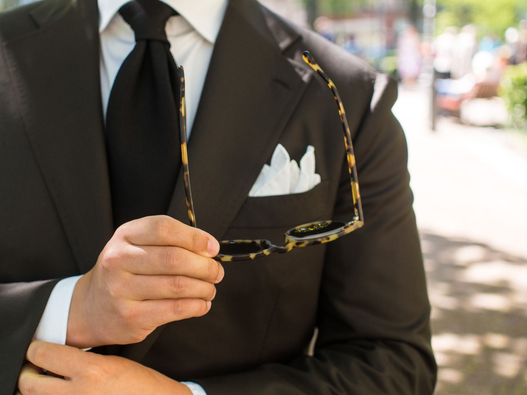 brown suit black tie