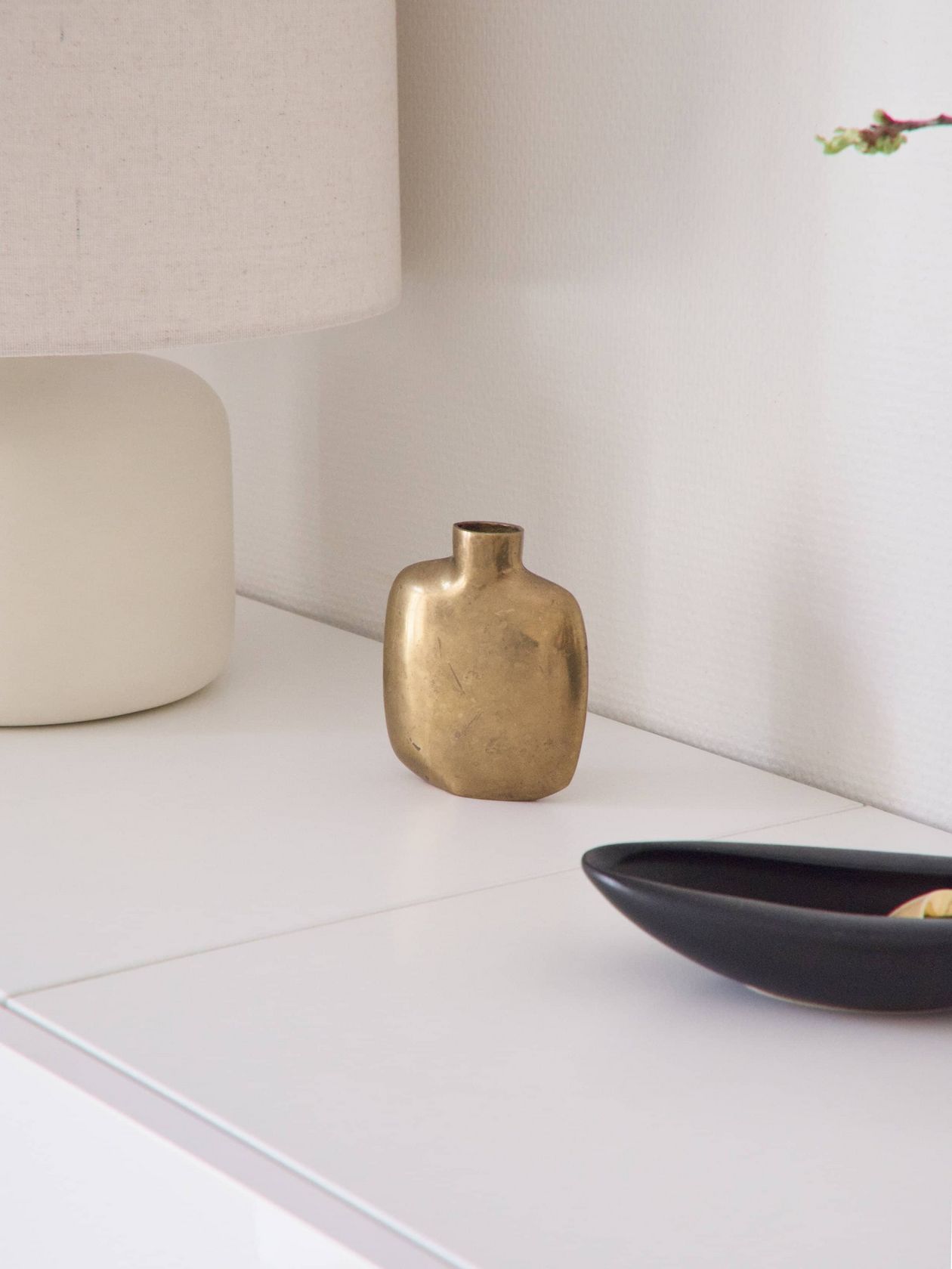Jenna Kiuru's home, golden vase on a drawer