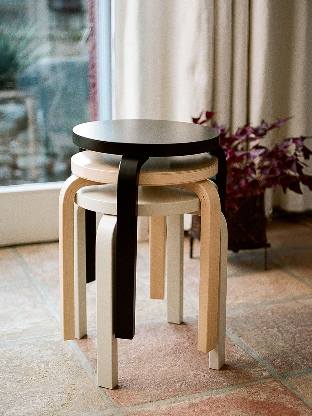 Pile of Aalto Stools in black, white and birch