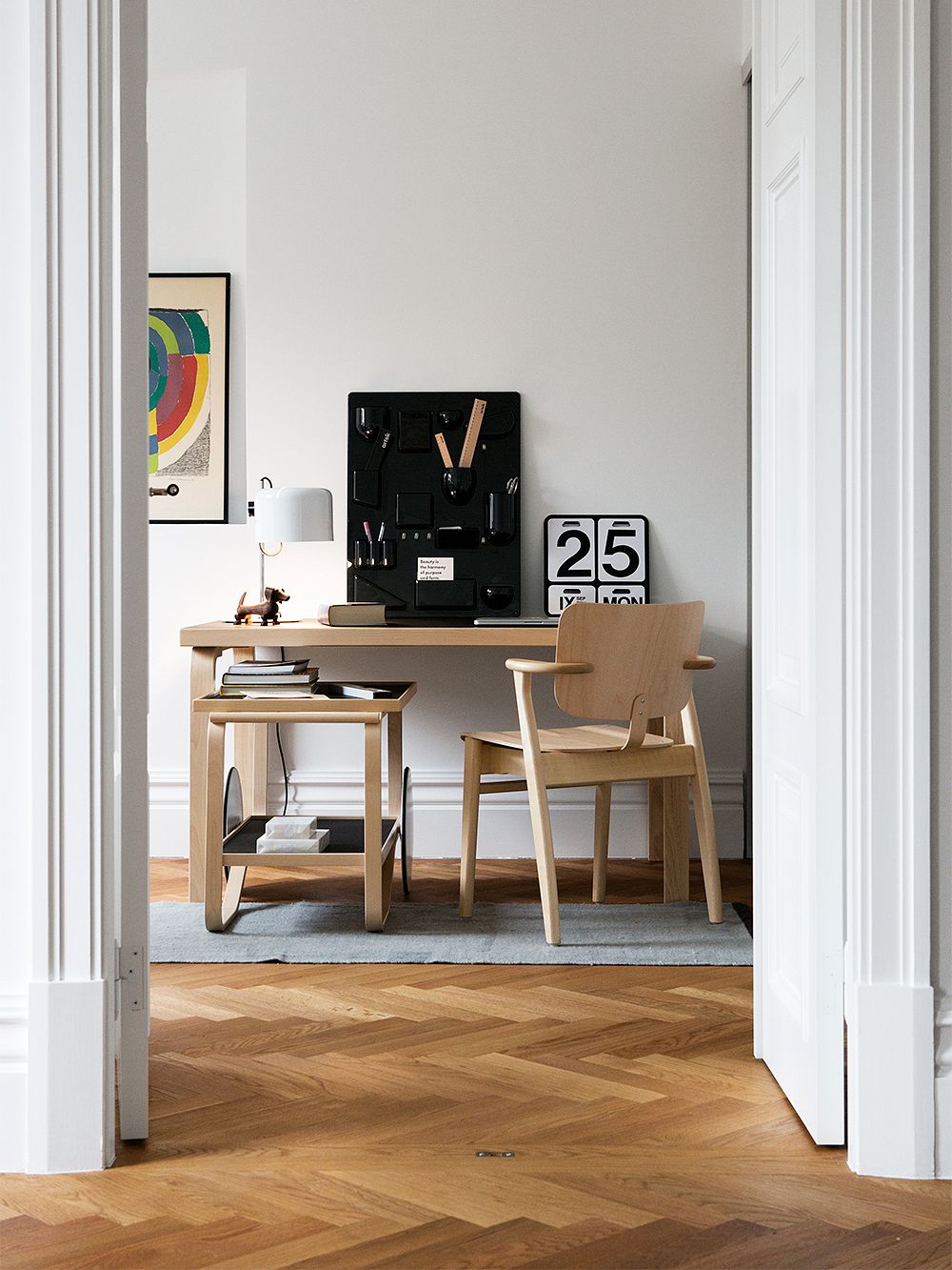 An image featuring Artek's Aalto table 80A, serving trolley 901 and Domus chair as part of a home office decor.