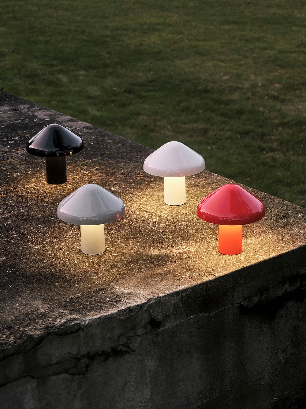 The Pao Portable table lamp glows in the dark in black, gray, white and red.
