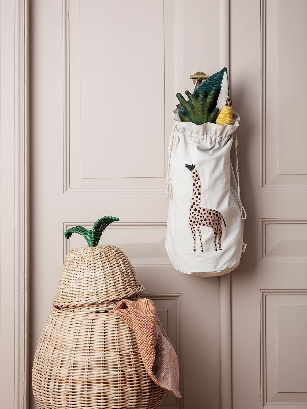 An image of ferm LIVING's rattan Pear basket as part of the kids' room decor.