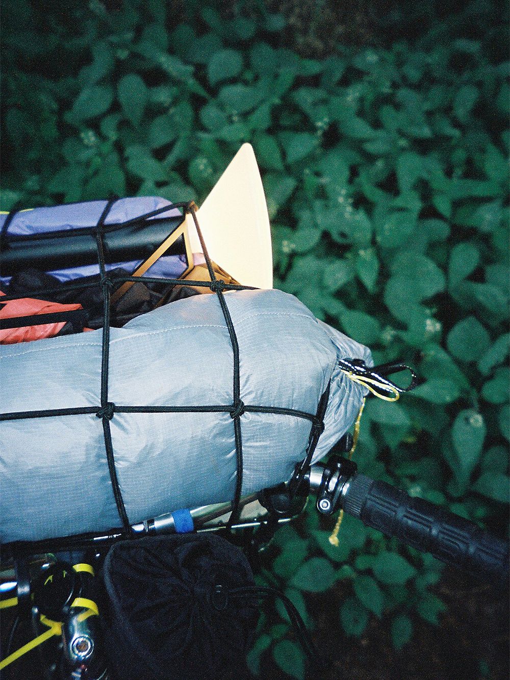 An image of Muuto's Piton luminaire strapped on a bike.