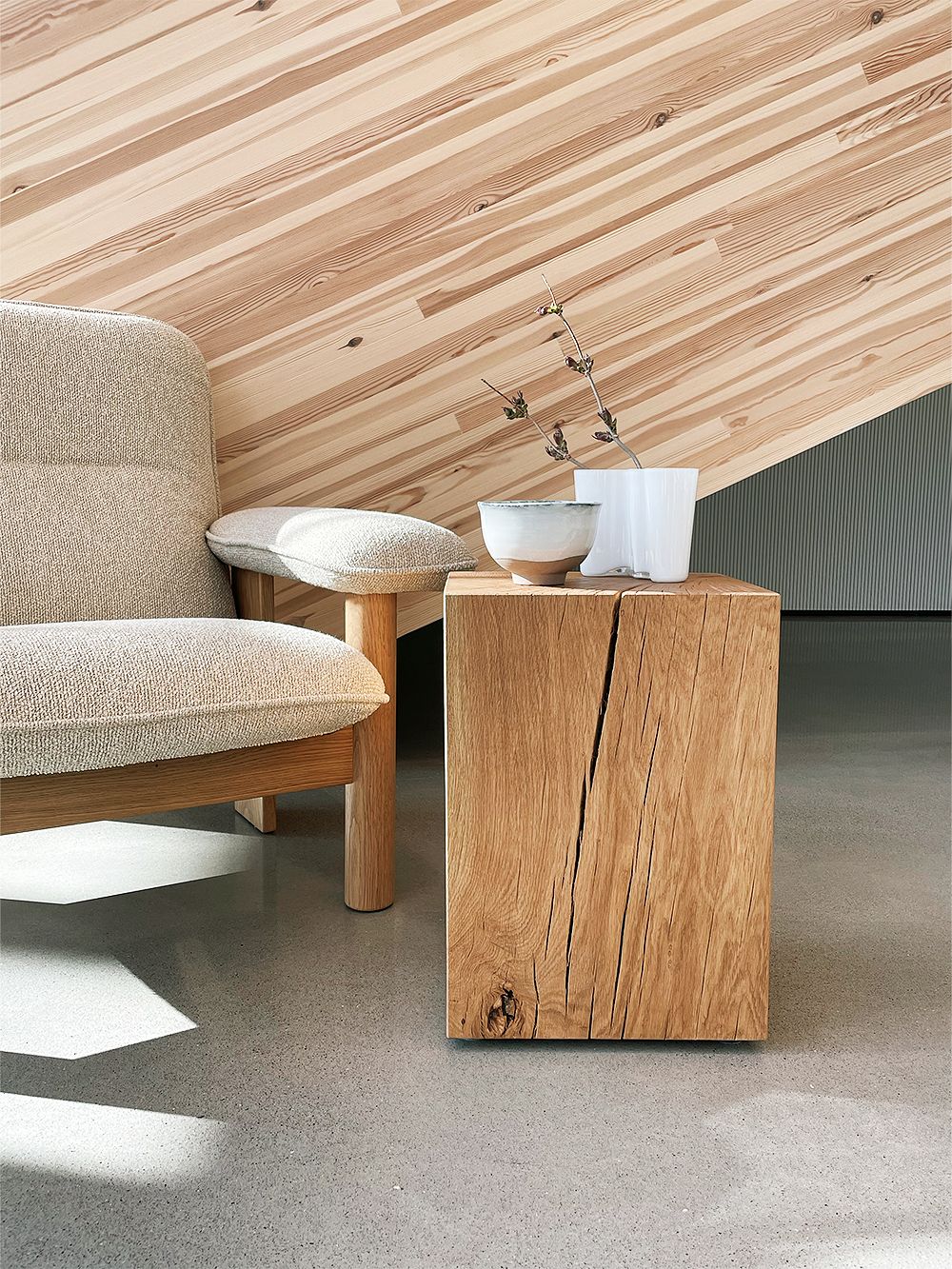 Nikari Biennale stool used as a side table next to Menu's Brasilia lounge chair