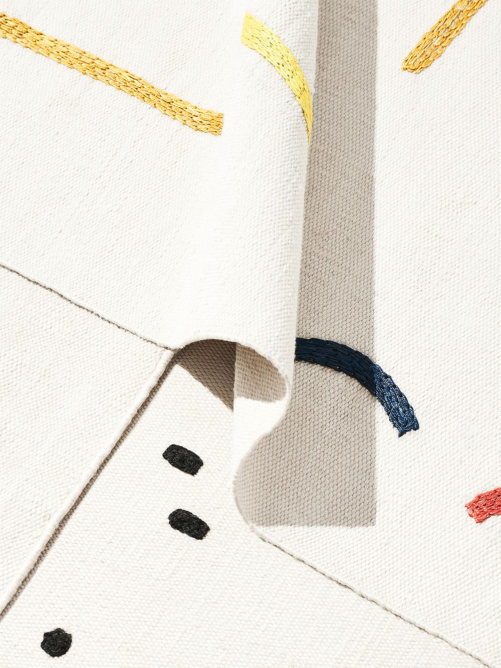 A close up image of several rugs from the Typewriter rug collection by Tomi Leppänen.