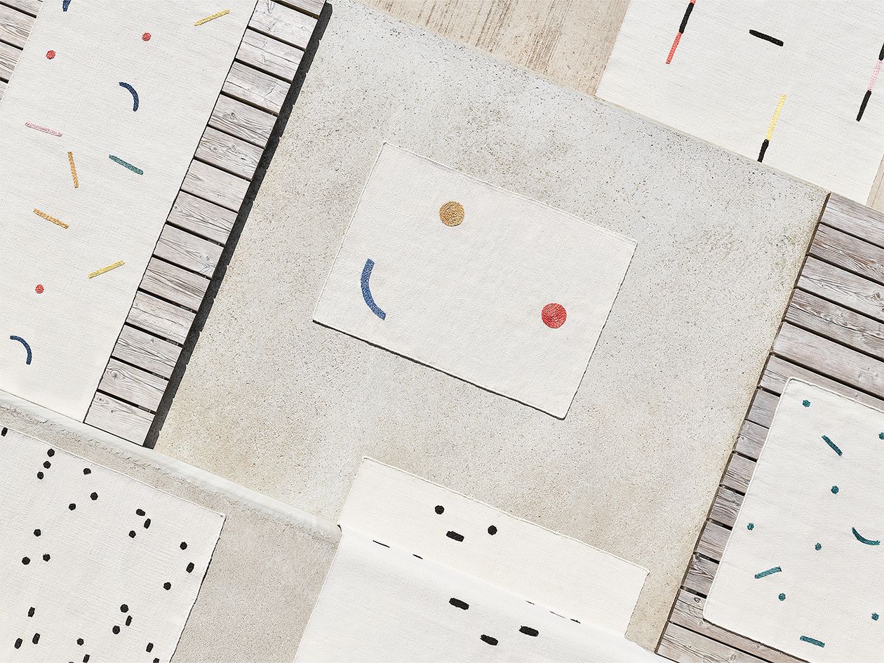 An image of several rugs from the Typewriter rug collection by Tomi Leppänen.