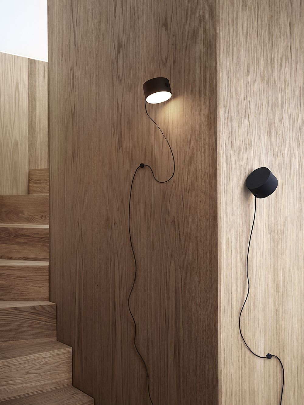 Muuto's Post wall lamp attached to the wall.