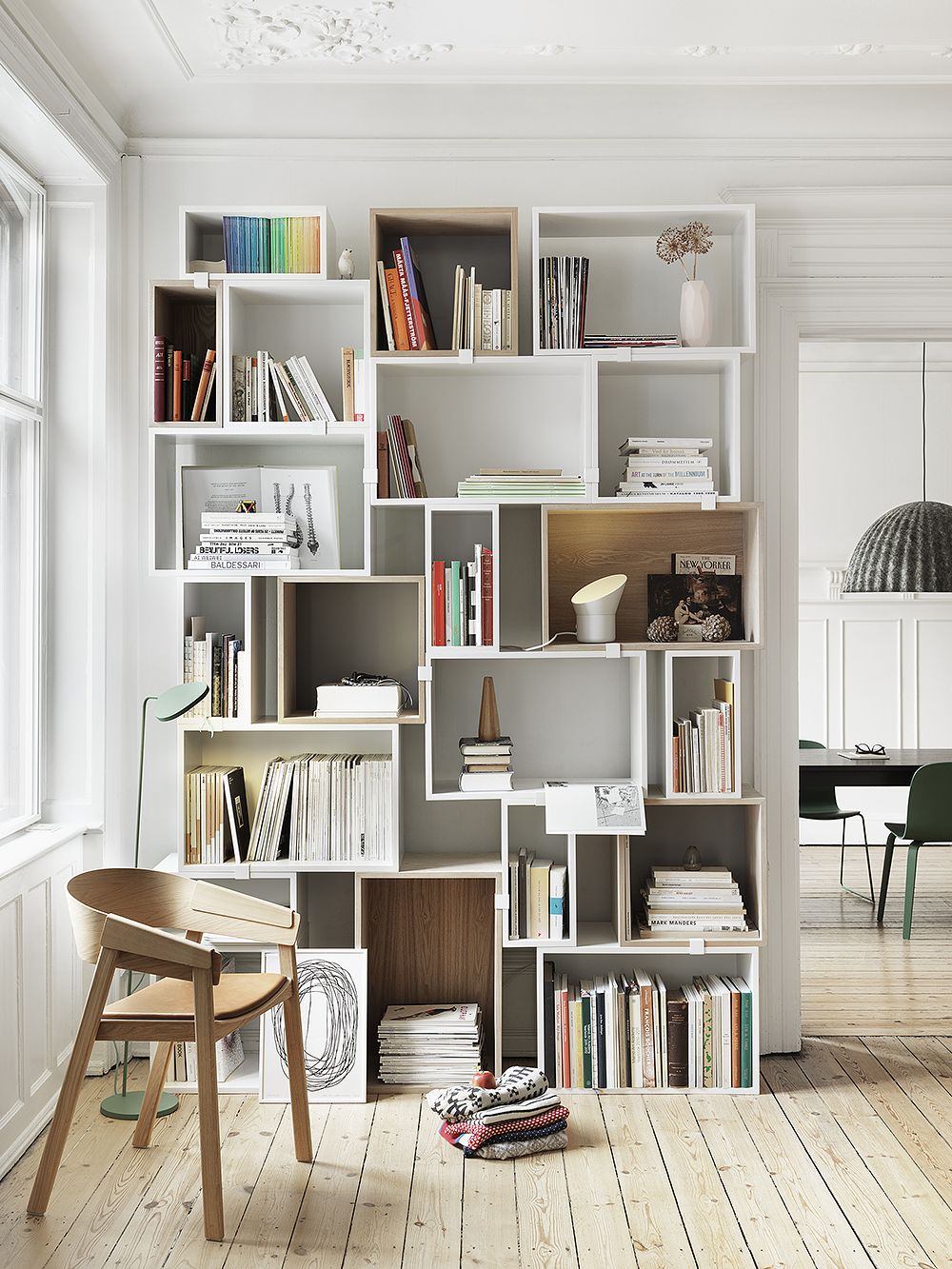 Muuto Stacked shelving modules piled onto the floor.