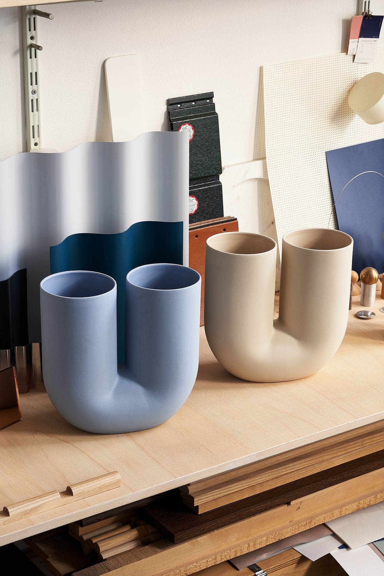 Muuto's Kink vase in light blue and sand.