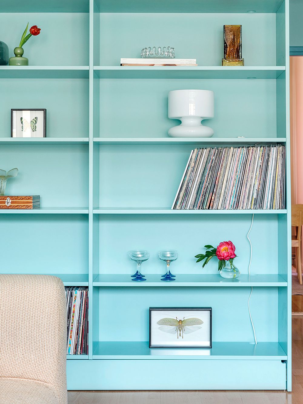A bespoke large blue bookshelf in the living room