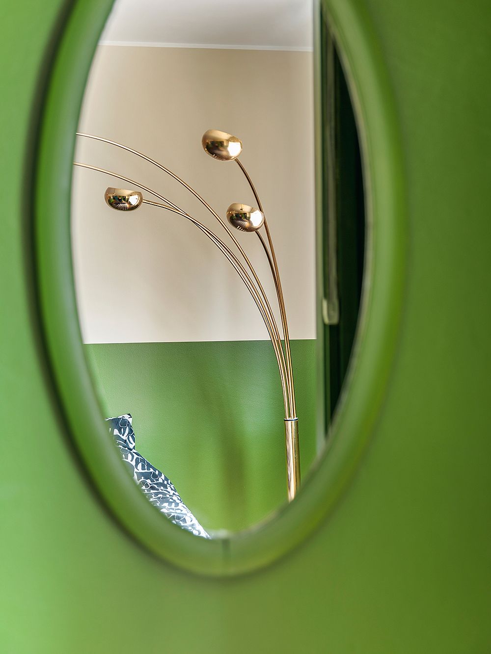 A brass floor lamp and a green wall