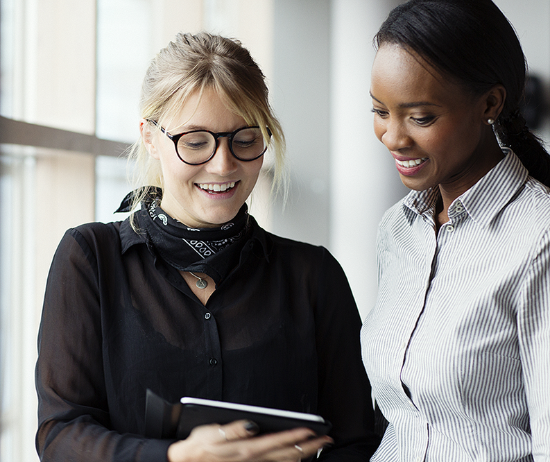 Two women looking at tablet