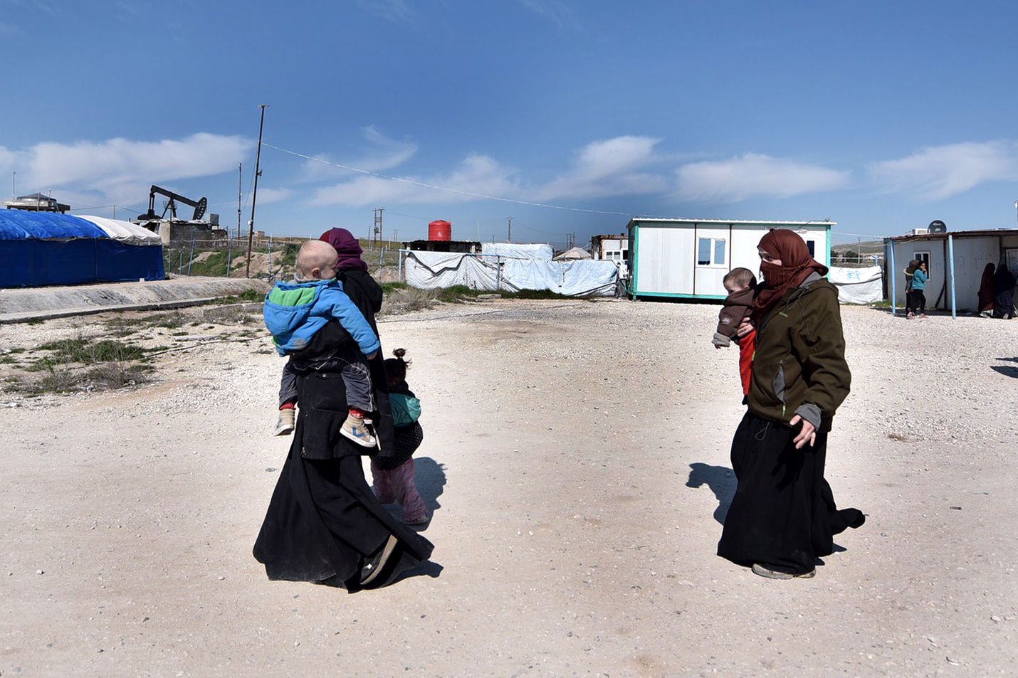 Mahdollisesti Isis-taistelijoiden vaimoja kävelemässä pakolaisleirillä Koillis-Syyriassa helmikuun lopulla. Isisin kokemien tappioiden myötä myös sen omia jäseniä pakenee järjestön aiemmin hallitsemista kaupungeista.