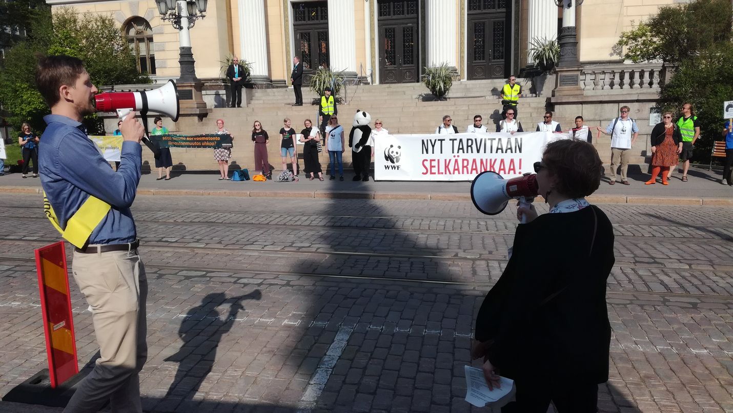 Ihmisketju huusi kannustusta neuvotteluissa olevien puolueiden puheenjohtajille ja vaati nopeita ilmastotekoja.