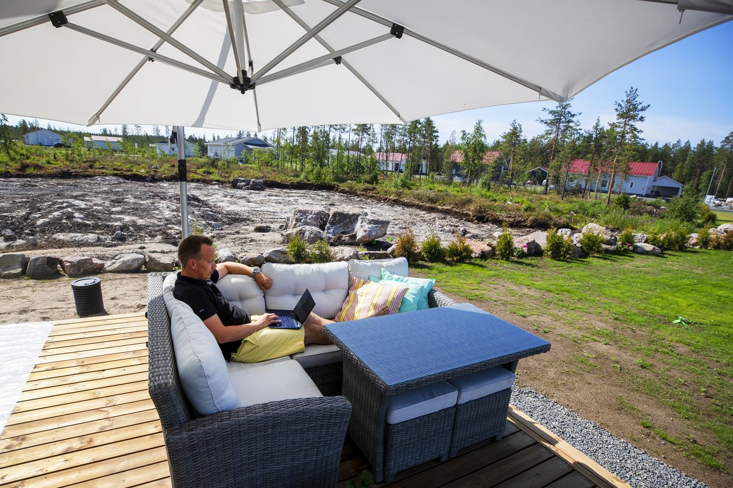 Tuomas Koiviston pihapiirissä ei ole puita, joten terassin työpisteelle käy mukavasti viilentävä tuuli. Ergonomiaan voisi kiinnittää enemmän huomiota, mutta ongelmia ei ole ollut.