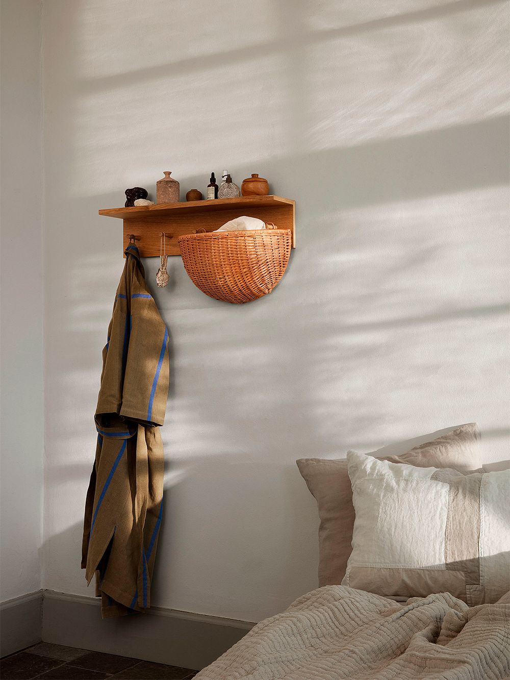 An image of ferm LIVING's Place rack and Braided wall pocket as part of the bedroom decor.
