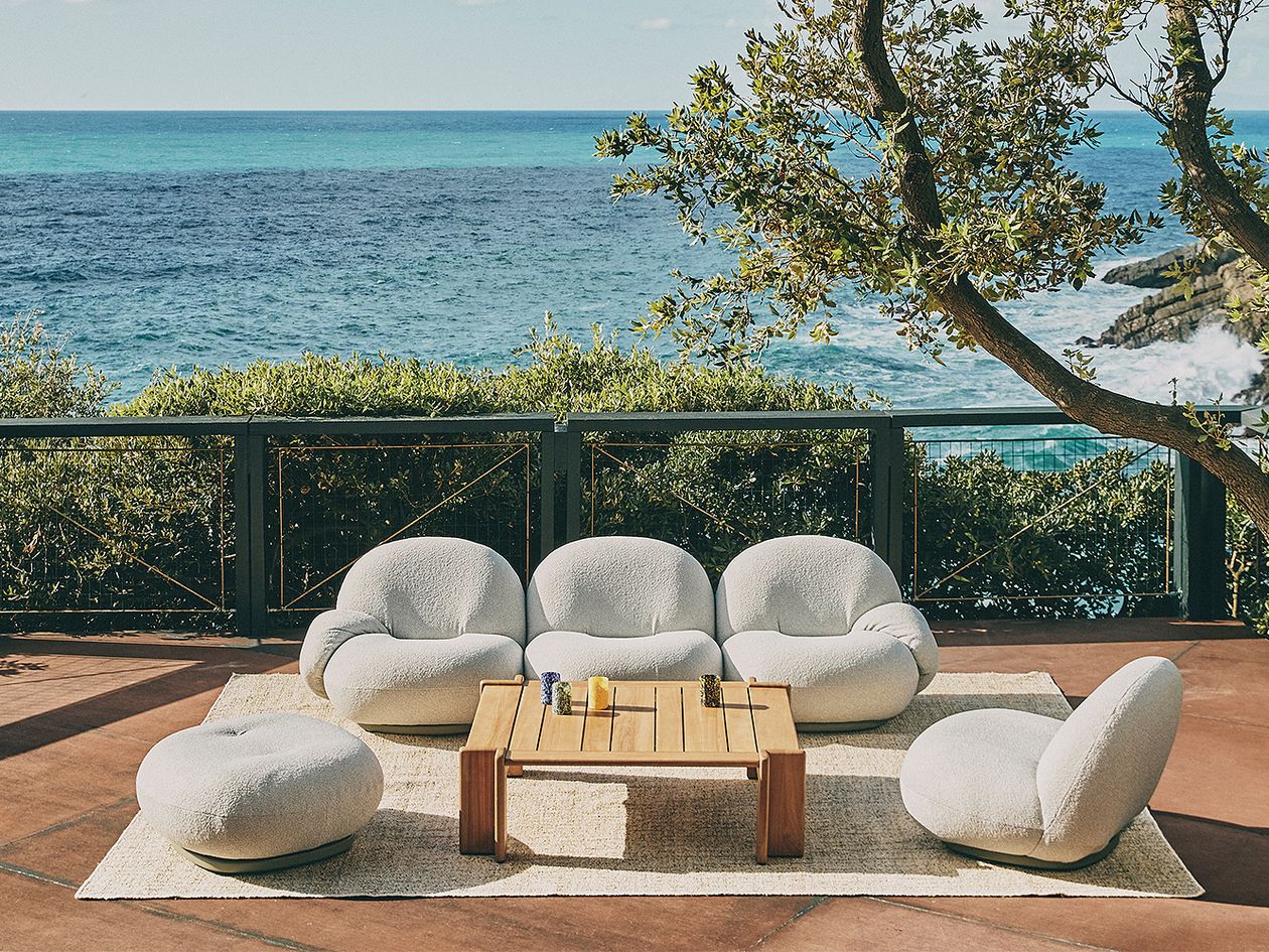 An image of GUBI Pacha Outdoor armchairs and Atmosfera coffee table on the patio.