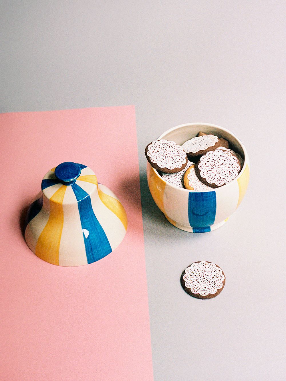An image with HAY's Sobremesa Stripe cookie jar against a pink background.