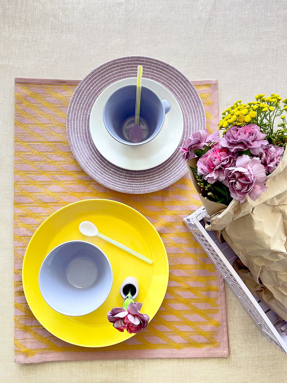 An image featuring Iittala's Teema tableware, Arabia's KoKo tableware and HAY's lavender Color Crate box in a colorful table setting, as part of the dining area decor. 