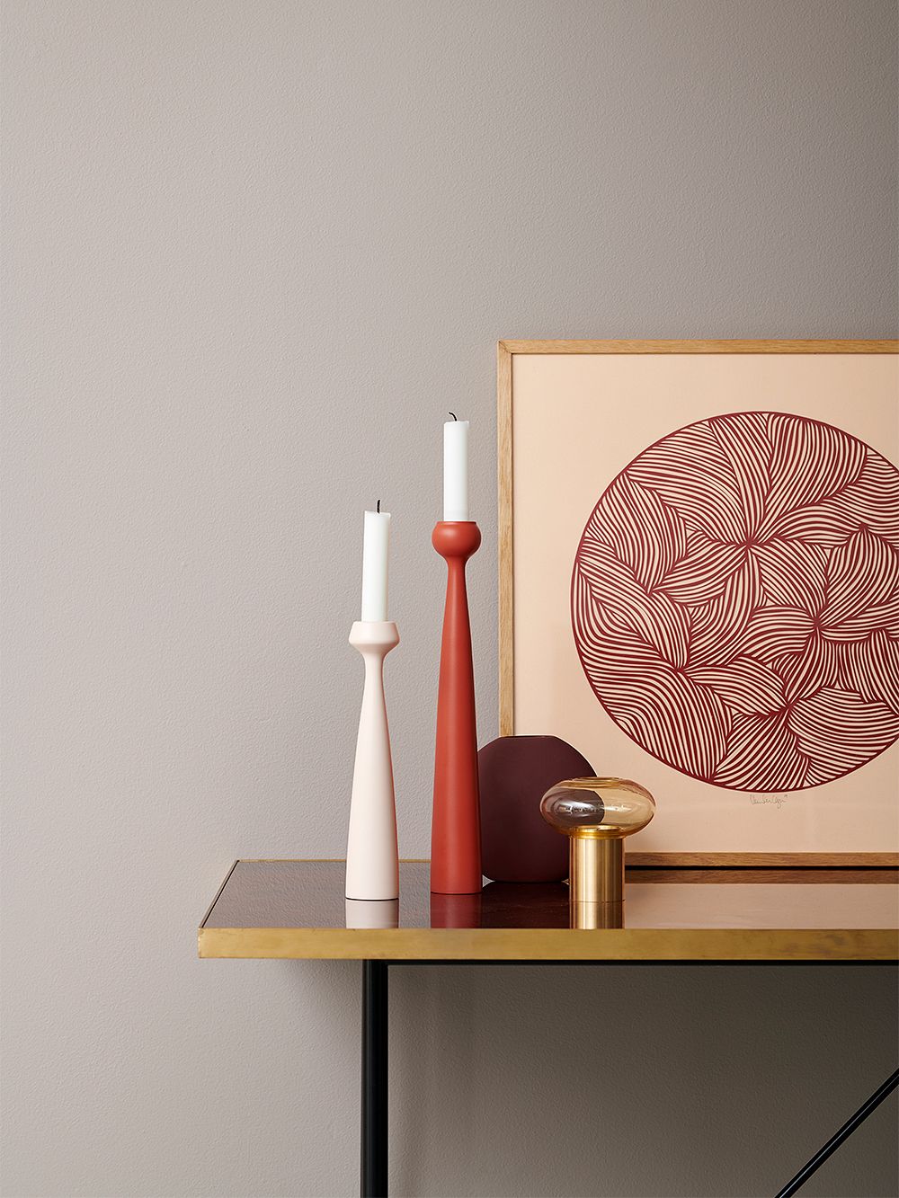 An image of applicata's Blossom candleholders in a light pink and a coral red hue, as part of the living room decor.