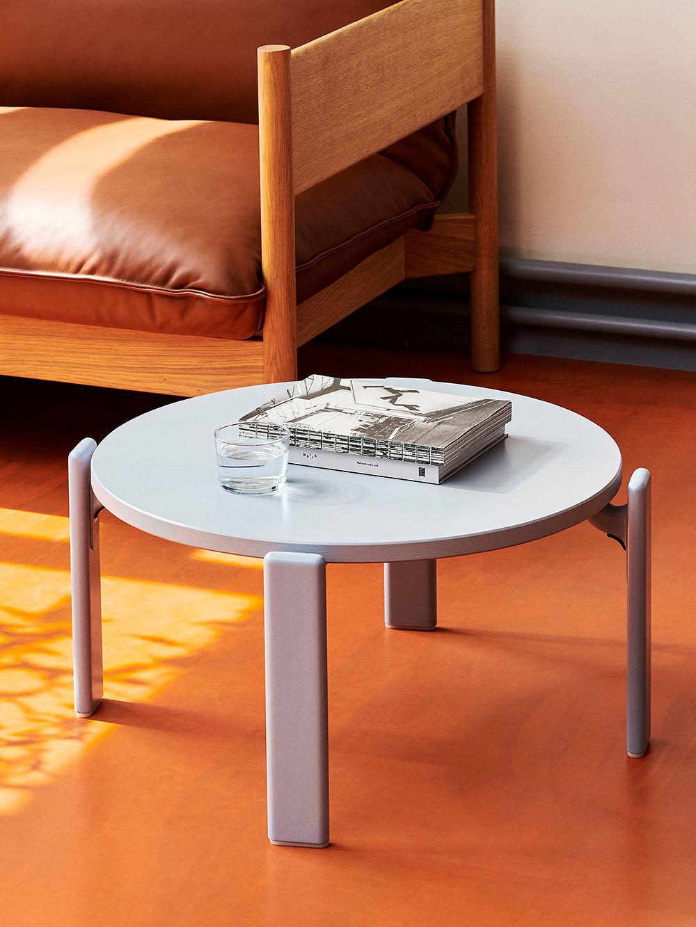 An image of HAY's Rey coffee table in a light blue color, as part of the living room decor.