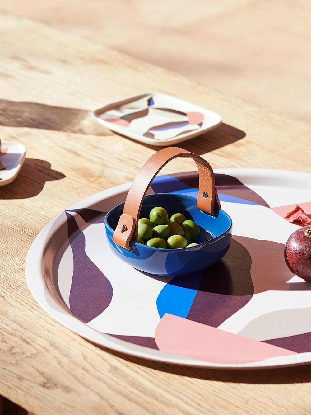 An image of Marimekko's Berry tray and Pikku Koppa serving dish in electric blue, as part of a table setting.