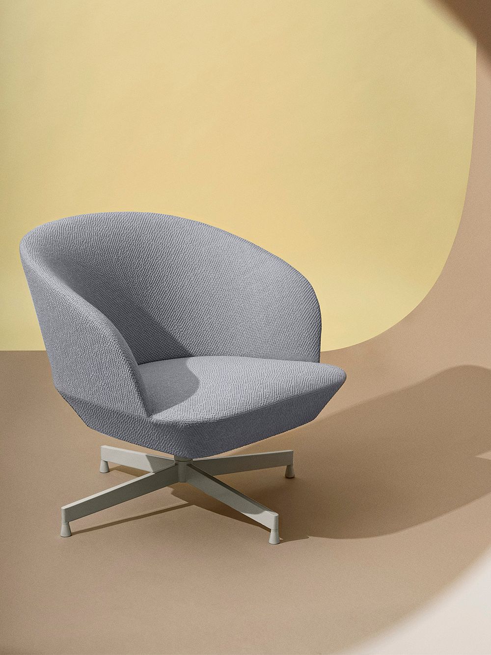 An image of Muuto's Oslo lounge chair with a swiveling base.