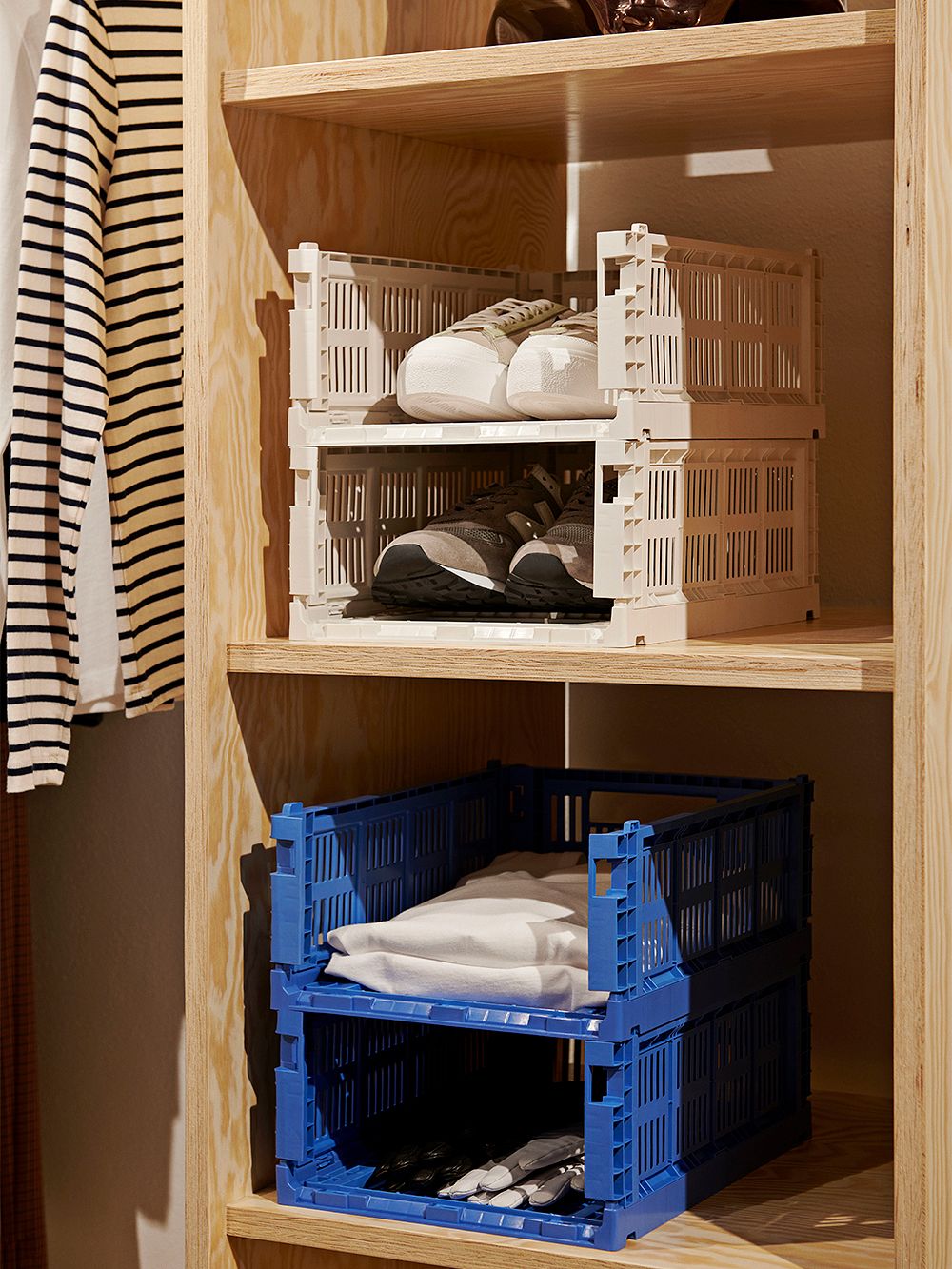 An image of HAY's Colour Crates in a cupboard, as part of the hallway or walk-in closet decor.