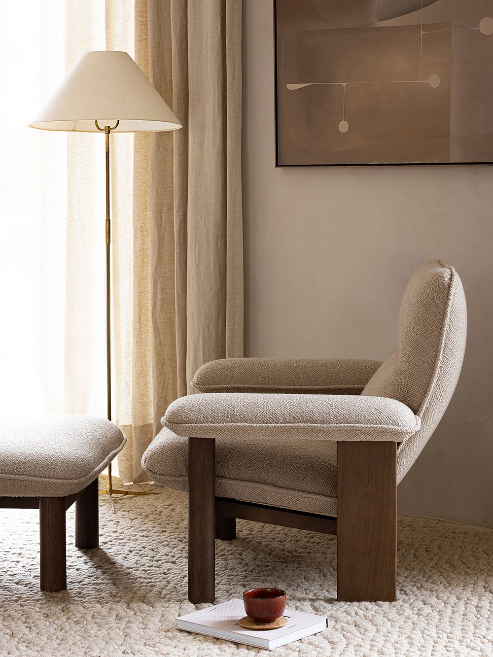 An image of Menu's Brasilia armchair and ottoman in a livingroom.