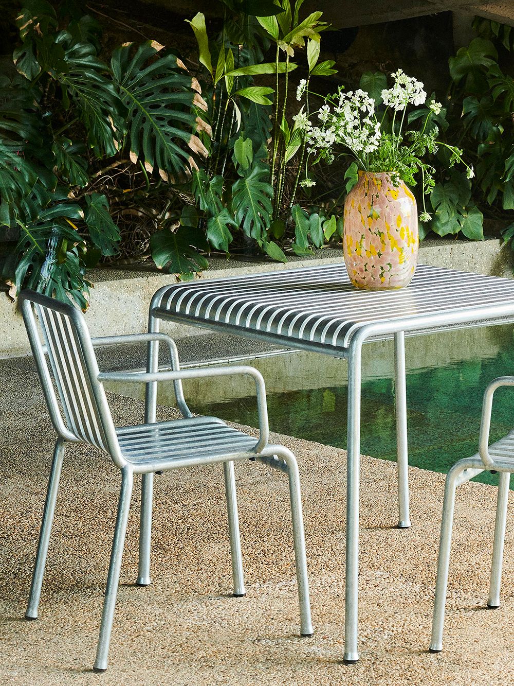 An image of HAY's Palissade patio furniture and Splash vase.