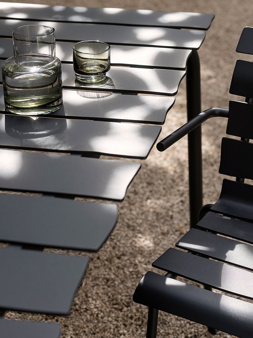 An image of Valerie Objects' Aligned patio furniture and Inner Circle carafe and glass.