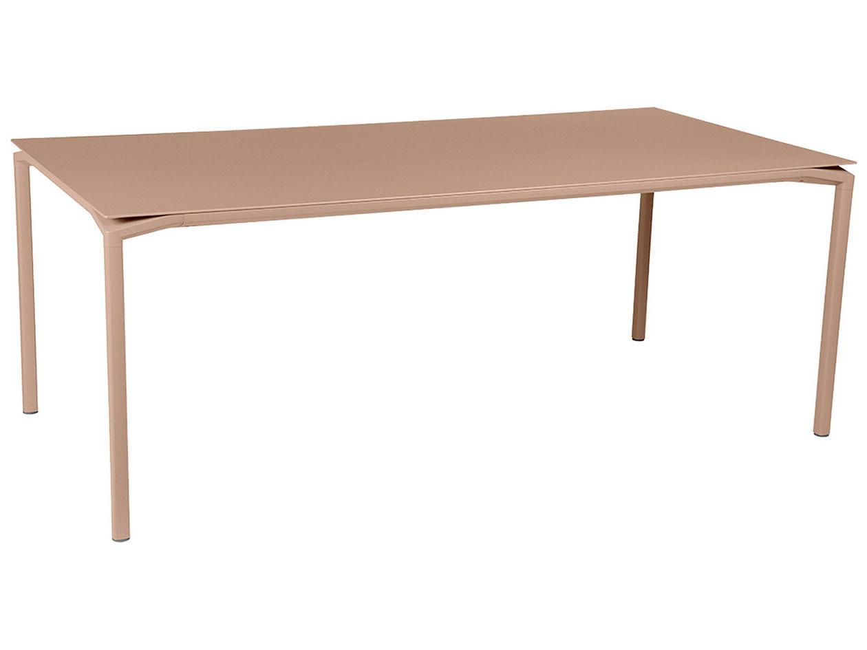 A product image of Fermob's Calvi table in a nutmeg shade.