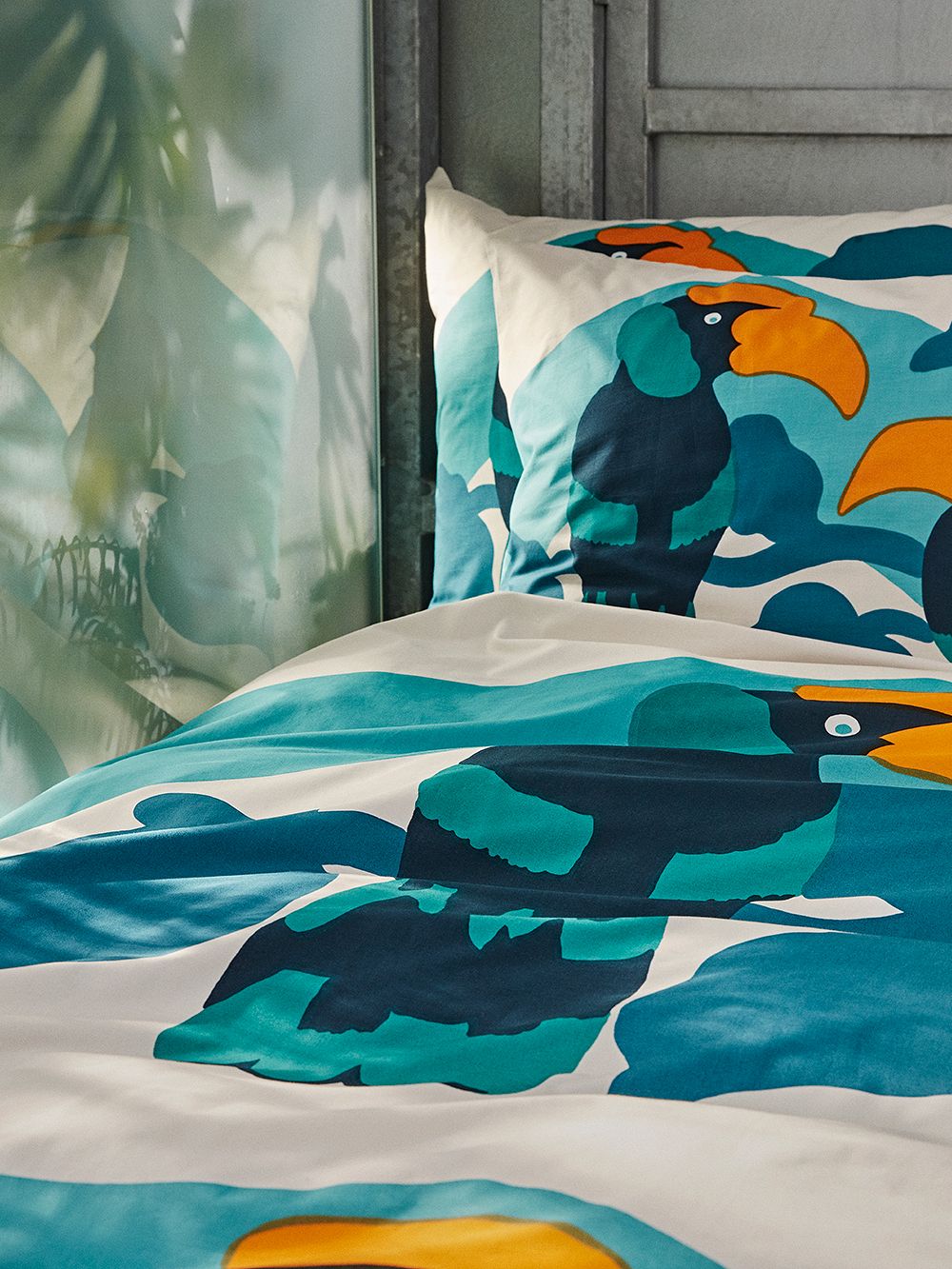 An image of Marimekko's Pepe duvet cover and pillow case on a bed.
