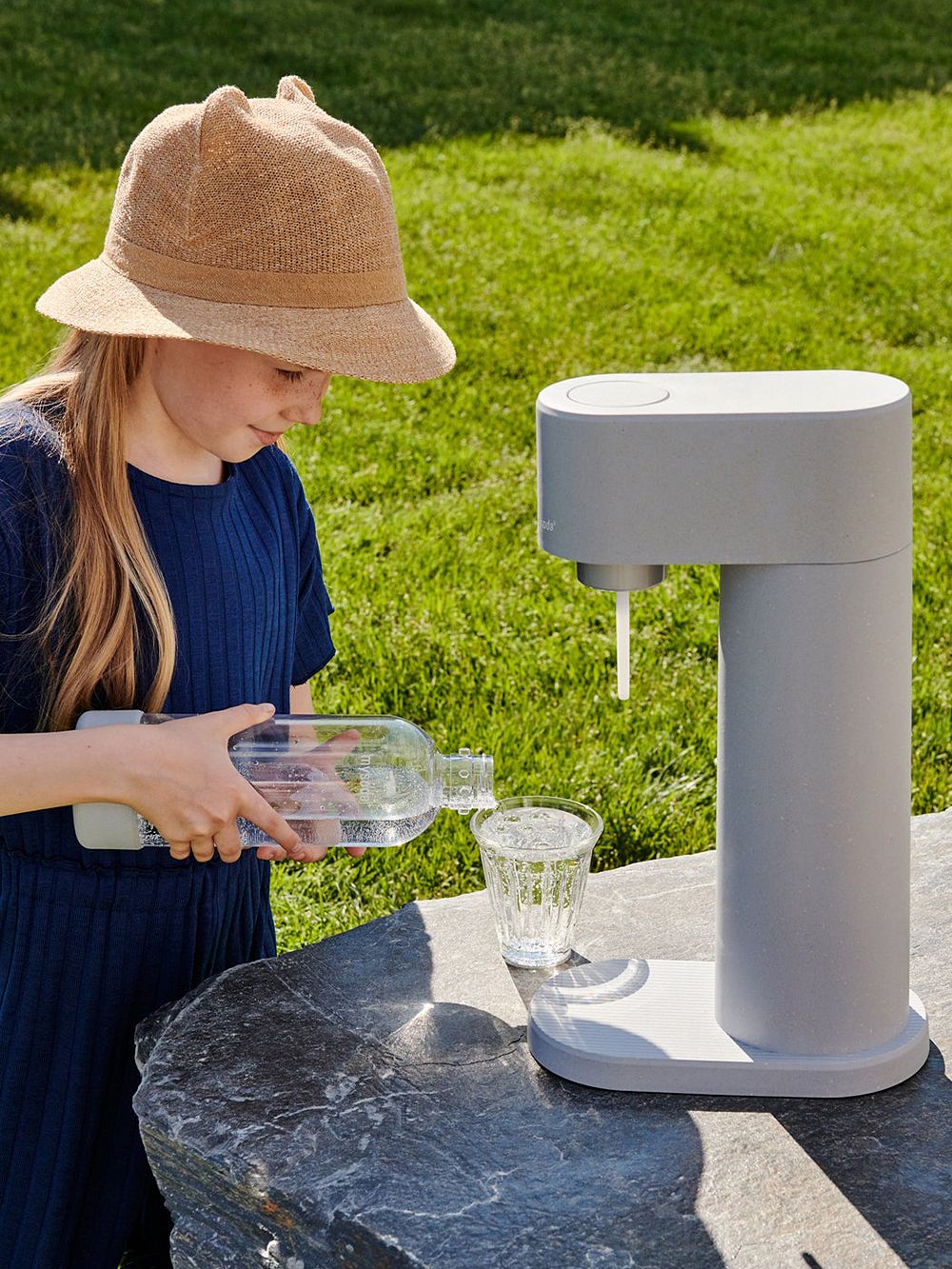 Woody sparkling water maker by Finnish brand Mysoda placed outside.