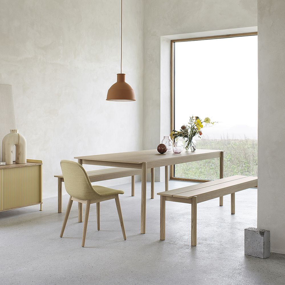 Muuto's Linear Wood dining table and Linear Wood benches in a dining area.