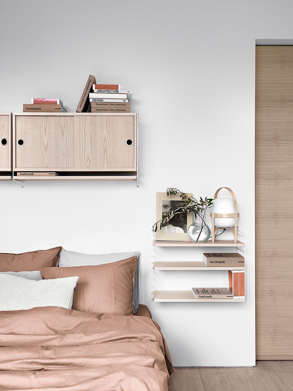 String Furniture's String Cabinet and String Pocket shelves in a bedroom.