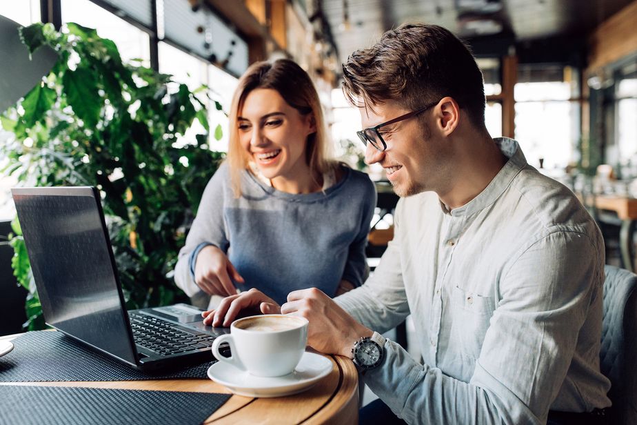 Un couple heureux devant un ordinateur