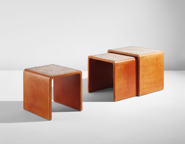 Retaining an organic quality while anticipating a more mechanized expression of the Art Deco style, Jean Dunand's set of three nesting tables seamlessly combine simplicity of form and geometric decoration. 