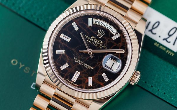 Rolex has crafted watch dials out of some of the world’s most exotic minerals for nearly 50 years. No less than 24 different semi-precious stones have been used in special examples of watches like the Day-Date, the Datejust, and the Daytona over the years. The newest hardstone dial to join the catalog came in 2021 – here’s everything you need to know about the “Eisenkiesel” Rolex Day-Date.