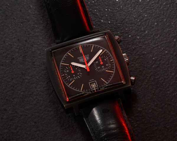 TAG Heuer's Heritage Director, Nicholas Biebuyck, explains the enigmatic transformation of the Heuer Monaco from a colorful and sporty chronograph, focused on the watch's functionality, into a black canvas, focused on the research of new materials, and texture. 