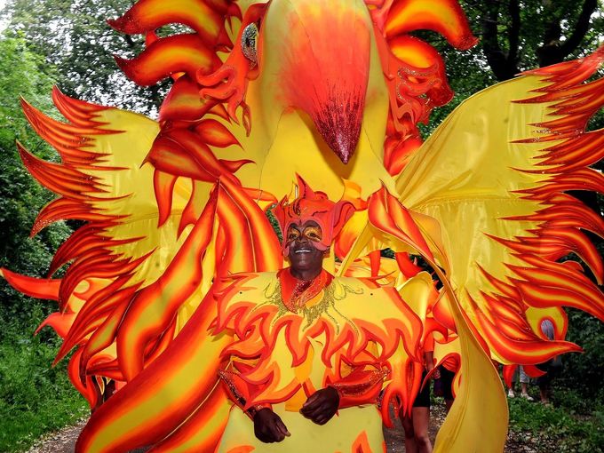 A person in a carnival costume of a phoenix taking part in the Sheffield carnival