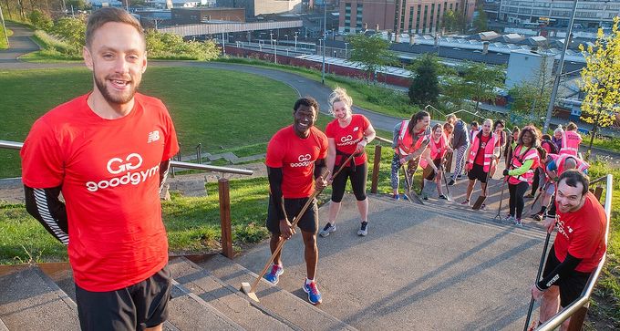 runners dressed in red goodgym tops sweeping the steps behind sheffield train station