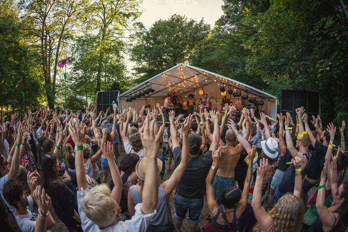 Crowd with their hands up in the woodland setting of The Folk Forest music festival in Sheffield City Centre