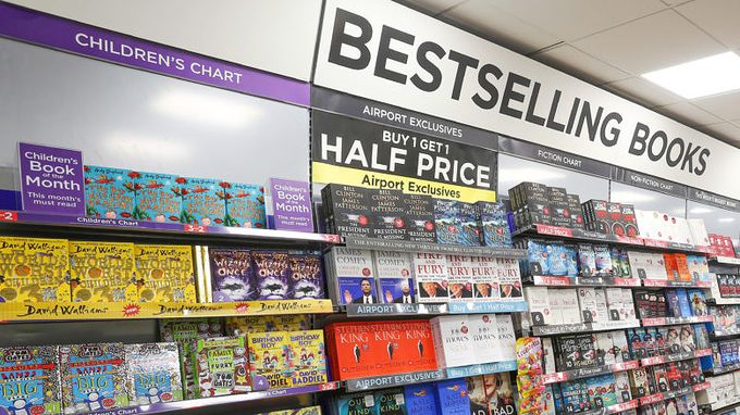 Shelves of books on a wall with bestselling books sign above it 